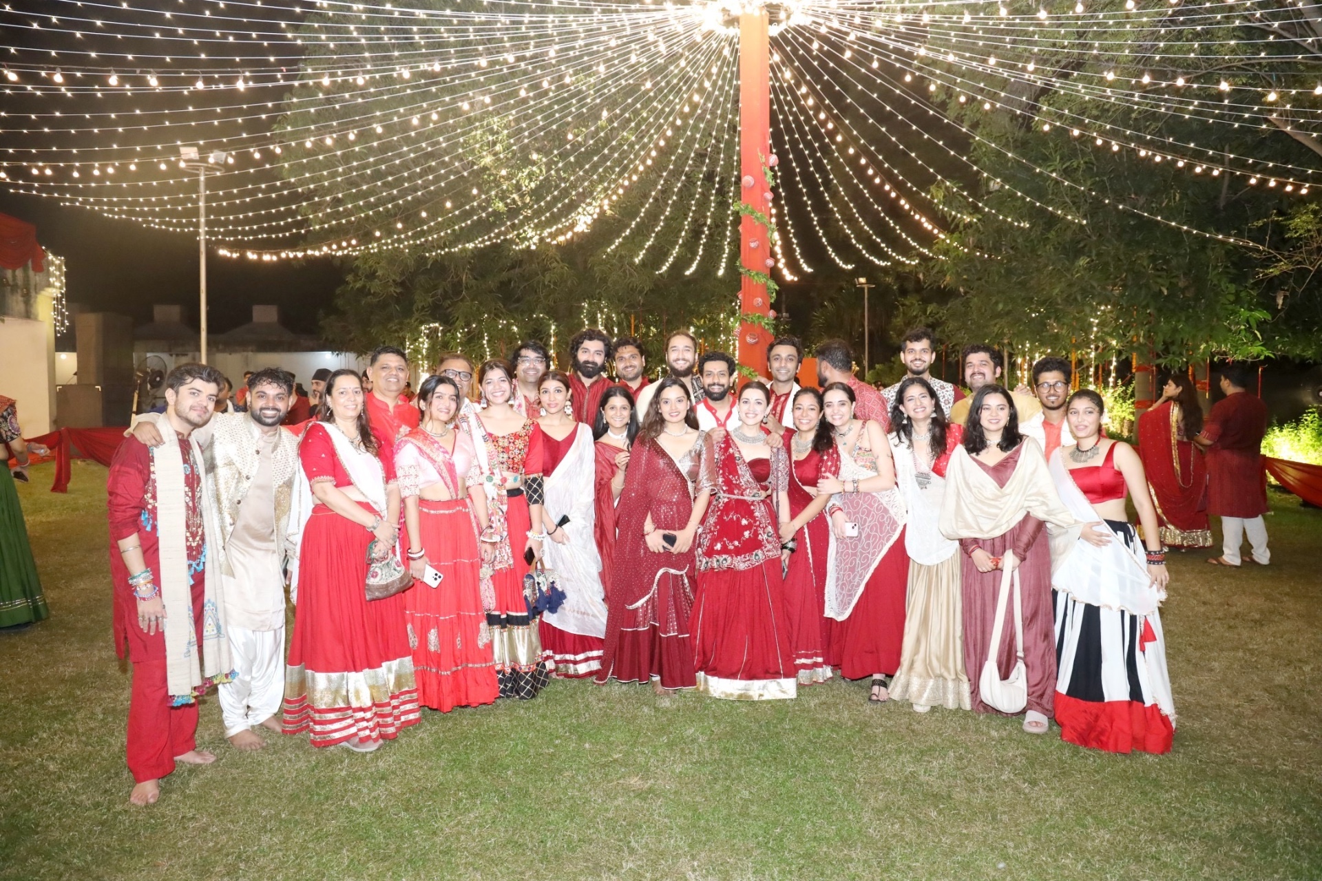 Friends posing under fairy lights