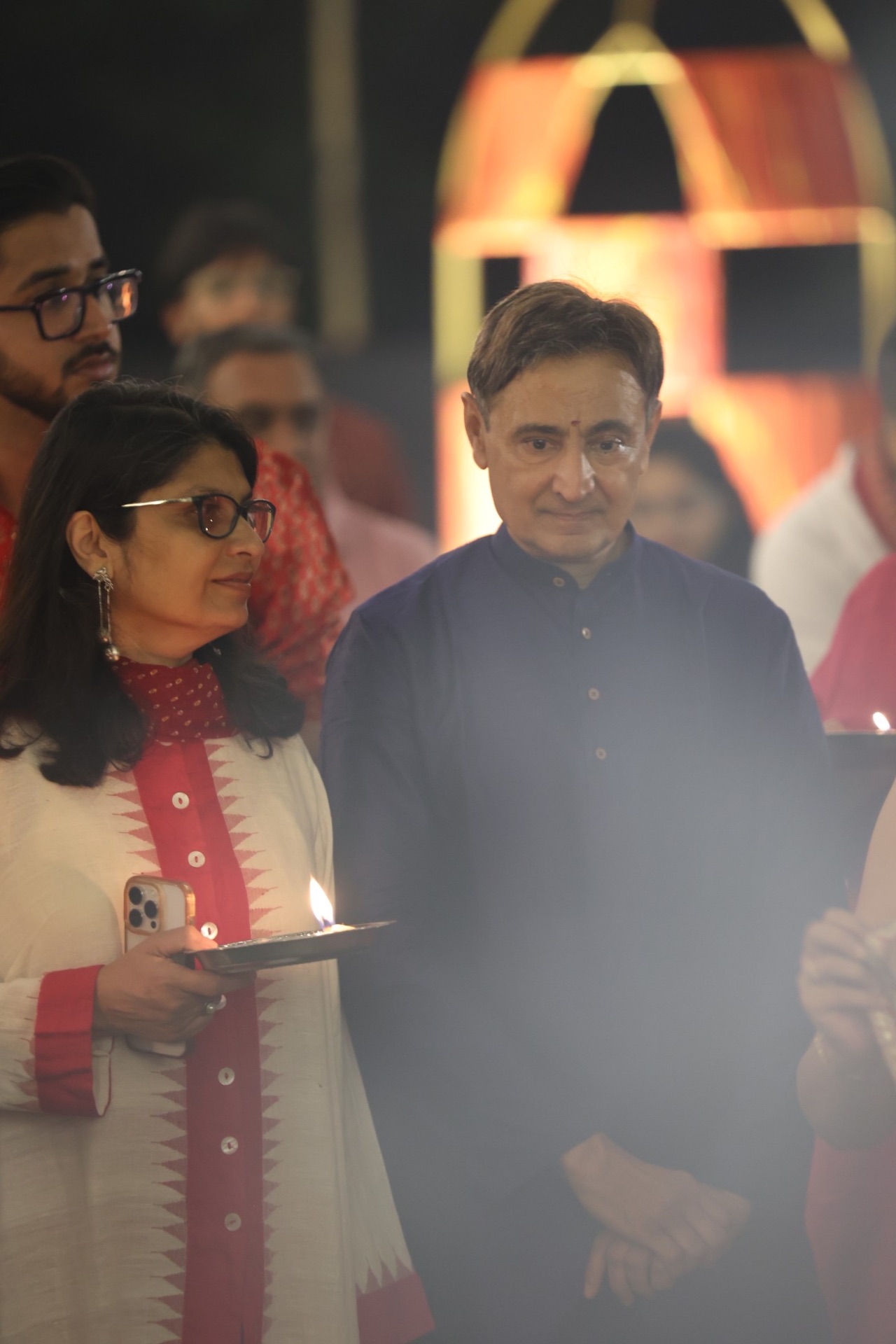 Couple holding a diya during aarti