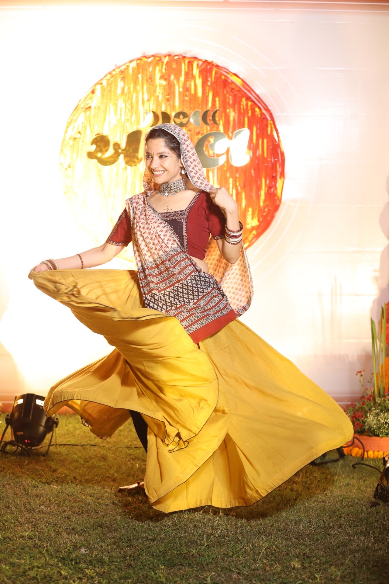 Dancer in yellow ghaghra mid-twirl on stage