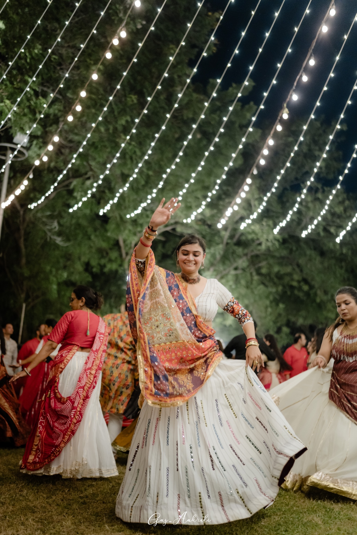 Twirl under string lights
